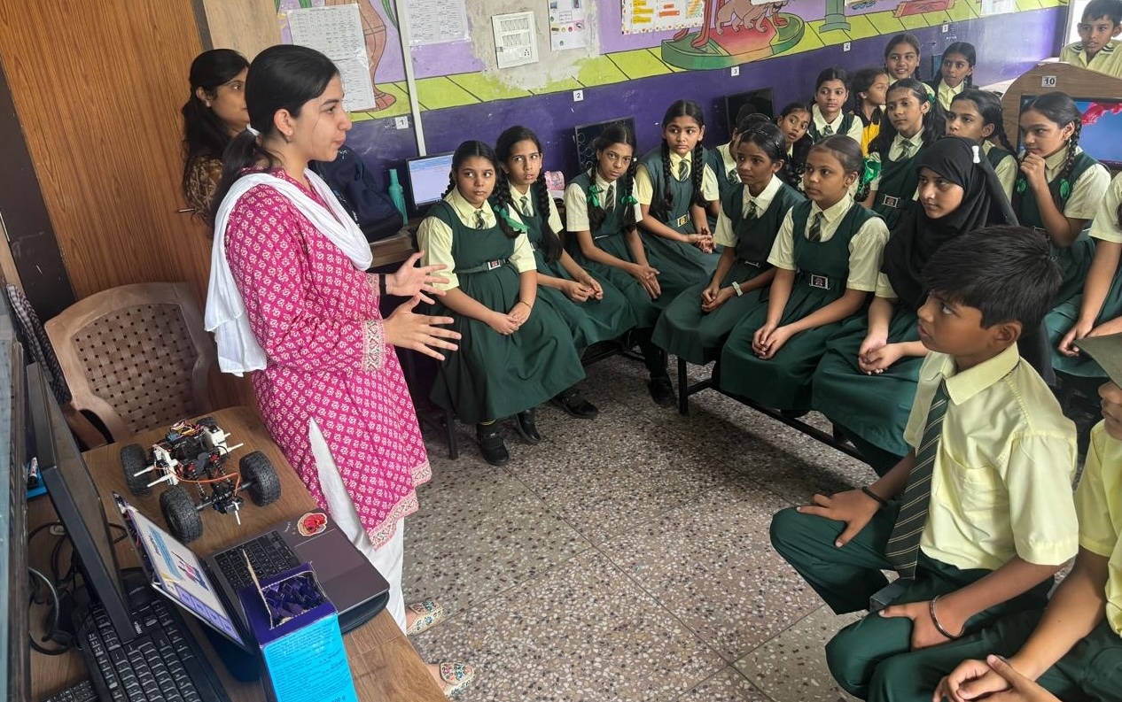DreamBig volunteer demonstrating a coding robot to a classroom